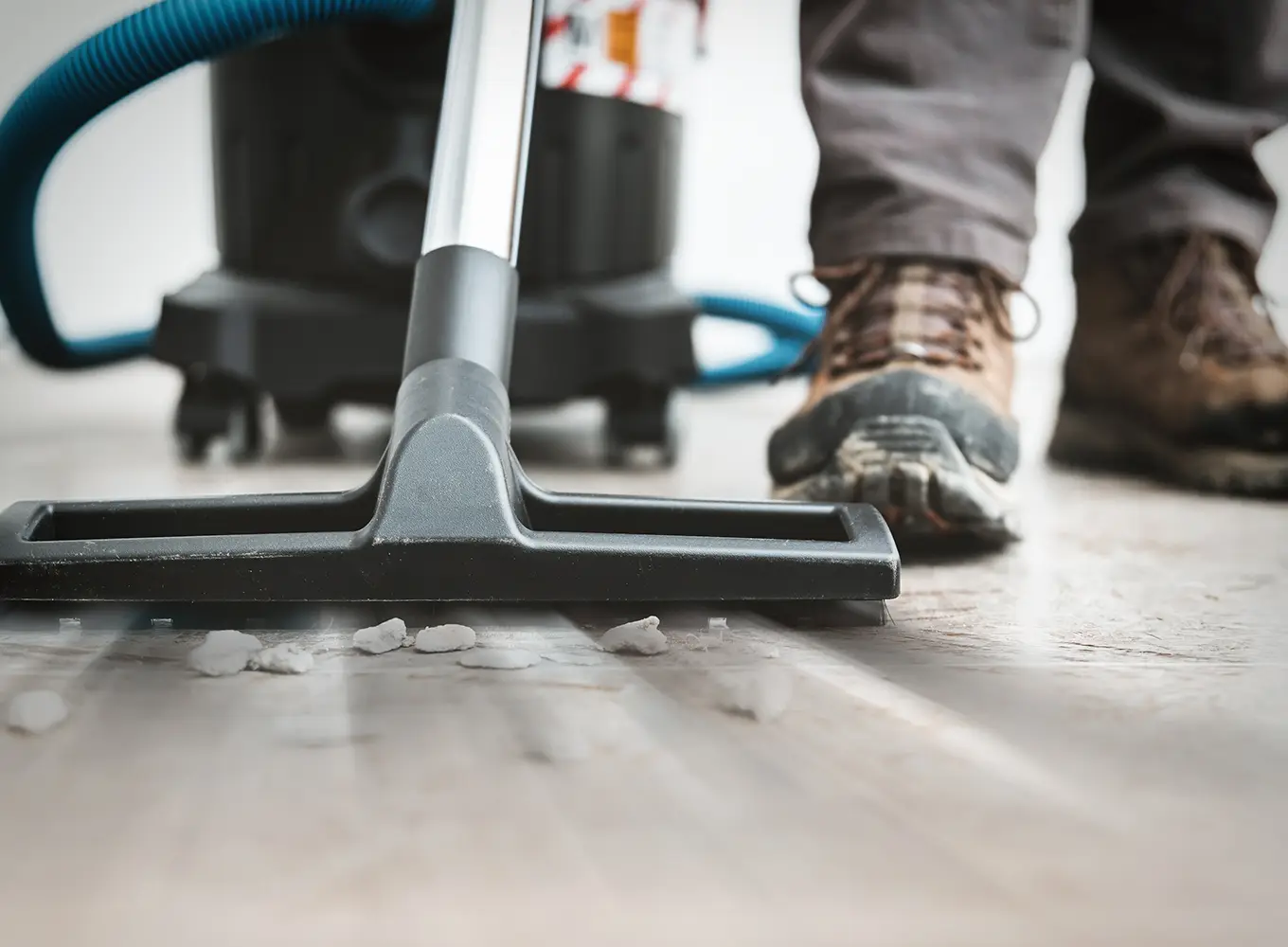 Clean Sweep LLC - a person vacuuming up rocks - post-construction cleaning services near O'Fallon, IL